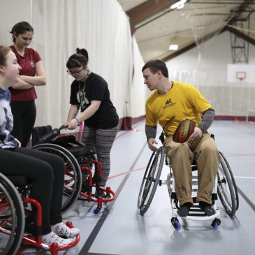 Brandon Merry ’15, senior program manager at Maine Adaptive Sports & Recreation in Newry, instructs students on how to use sport chairs prior to playing a game of wheelchair pickleball in UMF’s Fitness and Recreation Center.
