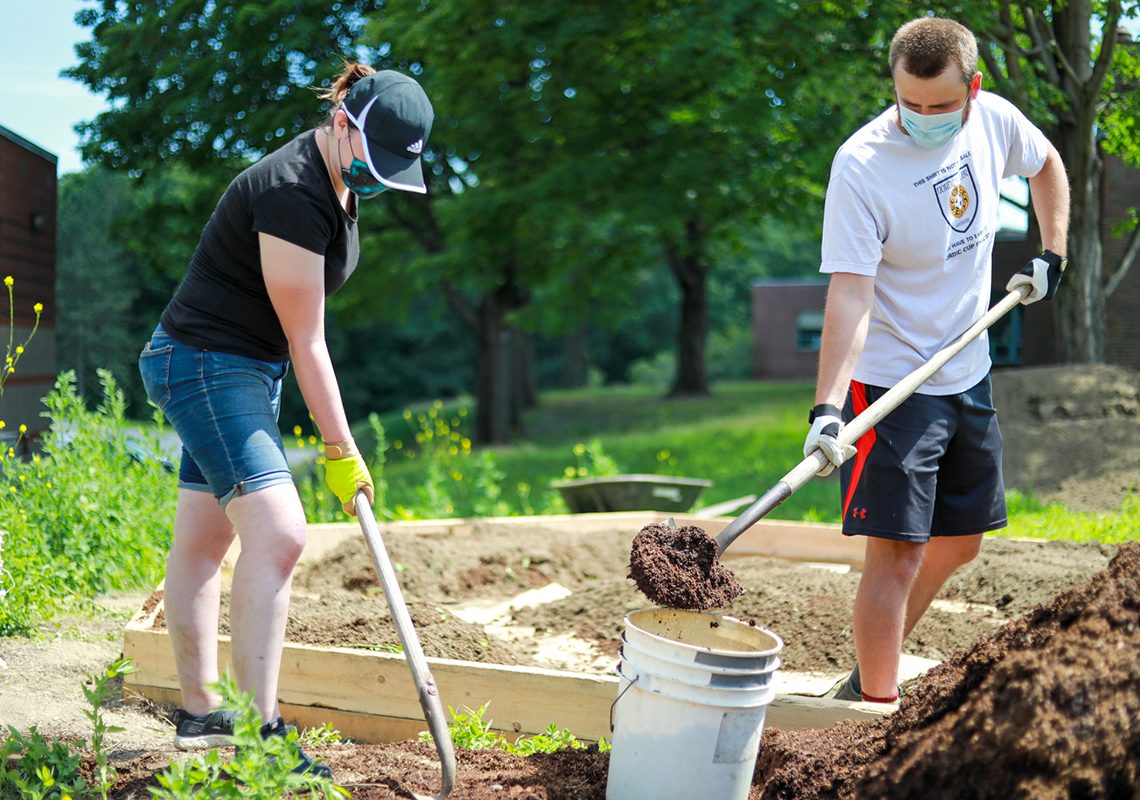 Left to right: Sara Taylor and James Cooke, UMF work-initiative students, helped create campus raised beds in addition to creating short videos and online drawings of the garden creation process.